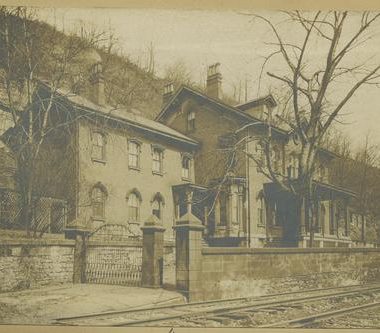 The Captain Samuel Brown Mansion before moving. Behind, the bluff is seen as well as the railroad infront.